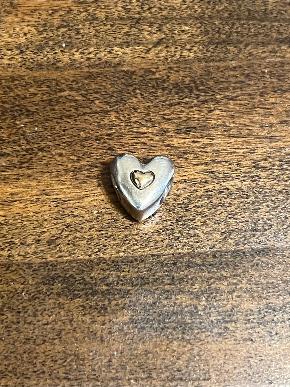 Pandora Silver Heart Charm with Gold Center.  Happy anniversary on the back!